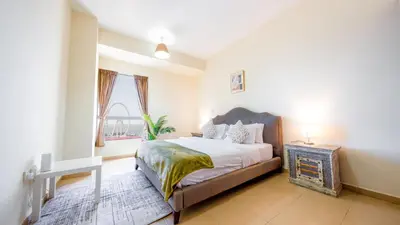 a bedroom with a large bed and a window at Luxury Casa - Paramount Sea View Apartment 2BR in Dubai