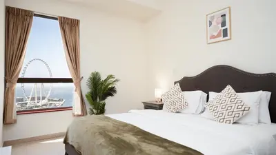 a bedroom with a bed and a window with a wheel at Luxury Casa - Paramount Sea View Apartment 2BR in Dubai