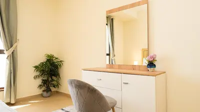 a dressing room with a mirror and a chair at Luxury Casa - Paramount Sea View Apartment 2BR in Dubai