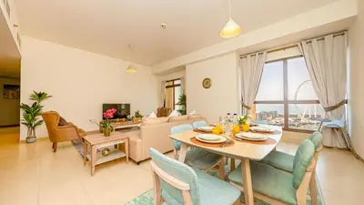 a dining room and living room with a table and chairs at Luxury Casa - Paramount Sea View Apartment 2BR in Dubai