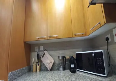 a kitchen with a counter with a microwave and a counter top at Bay Square studio Bay view in Dubai
