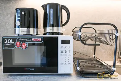 a coffee maker sitting on top of a microwave at New Studio In Arjan by Deleguest in Dubai