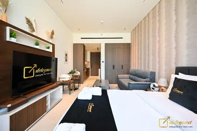 a hotel room with a bed and a flat screen tv at New Studio In Arjan by Deleguest in Dubai