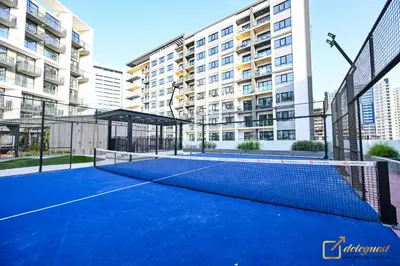 a tennis court in front of a building at New Studio In Arjan by Deleguest in Dubai
