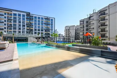a swimming pool in a building with tall buildings at New Studio In Arjan by Deleguest in Dubai