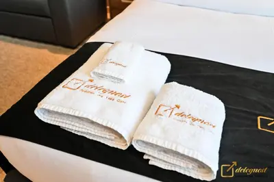 two white towels are sitting on top of a bed at New Studio In Arjan by Deleguest in Dubai