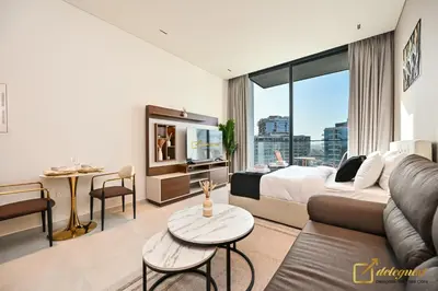a hotel room with a bed and a living room at Modern Studio in Arjan by Deleguest in Dubai