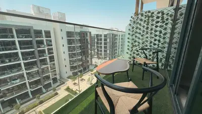 a balcony with a chair and a view of a city at Relaxing Retreat in Meydan in Dubai