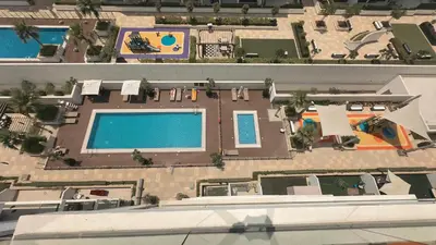 an overhead view of a swimming pool and a house at Relaxing Retreat in Meydan in Dubai