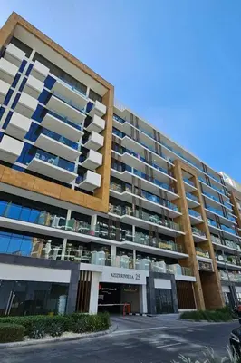 a large apartment building with a parking lot at Relaxing Retreat in Meydan in Dubai