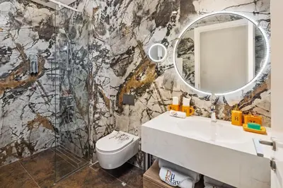 a bathroom with a sink and a mirror at Lagoon Charm Luxurious Waterfront Living in Dubai