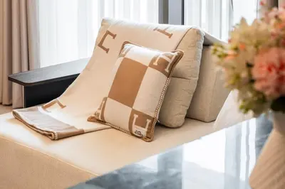 a pillow on a couch in a living room at Lagoon Charm Luxurious Waterfront Living in Dubai
