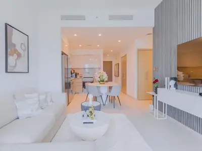 a living room with a white couch and a table at TRPS - Burj Royale, Downtown Dubai - 2BR - Burj Khalifa View - Furnished & Ready in Dubai