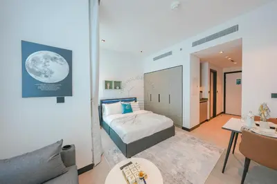 a small bedroom with a bed and a couch at Stylish Retreat in Business Bay in Dubai