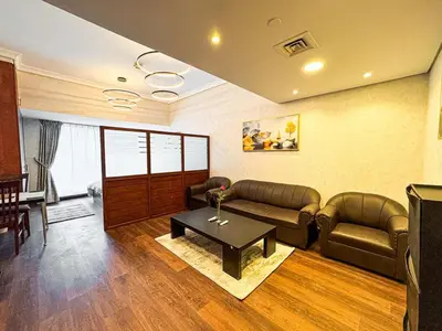 a living room with couches and a table in a room at Fully Furnished Studio Lake Terrace, JLT Prime Location by Al sarya Holiday Homes in Dubai