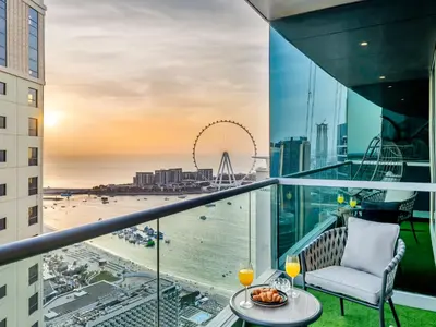 a balcony with a table and a chair and a view of the beach at WonderfulStay at Marine Towers - Full Ain & Marina View - JBR Grande Living - Brand New Apartments in Dubai