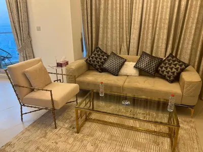 a living room with a couch and a chair at Elegant 1 Bedroom Apartment, The Lofts West Tower, Downtown Dubai By Al sarya Holiday Homes in Dubai