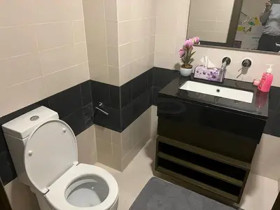 a bathroom with a toilet and a sink at Elegant 1 Bedroom Apartment, The Lofts West Tower, Downtown Dubai By Al sarya Holiday Homes in Dubai