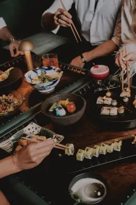 a group of people sitting around a table with sushi at FIVE Palm Jumeirah Hotel Apartments in Dubai