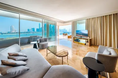 a living room with a couch and a view of the city at FIVE Palm Jumeirah Hotel Apartments in Dubai