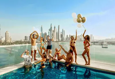 a group of people in the pool at a hotel at FIVE Palm Jumeirah Hotel Apartments in Dubai