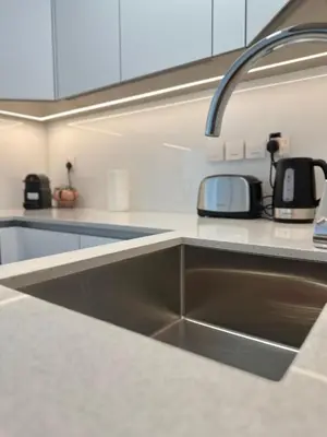 a kitchen counter with a sink in a kitchen at Cosy Studio - Luma 22 in Dubai