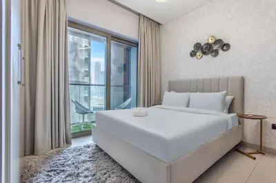 a bedroom with a large white bed and a window at STAY BY LATINEM Luxury 1BR Holiday Home CVR B803 Near Burj Khalifa in Dubai