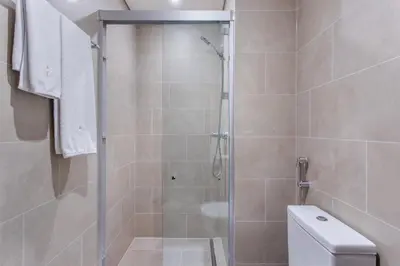 a bathroom with a shower and a toilet at STAY BY LATINEM Luxury 1BR Holiday Home CVR B803 Near Burj Khalifa in Dubai