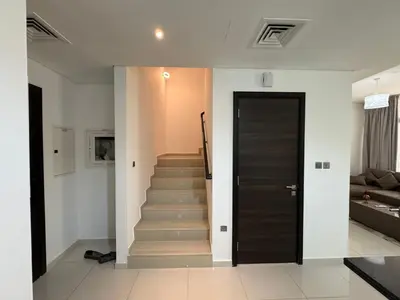 a hallway with a door and stairs in a house at 3 Bedroom Villa in Vardon Cluster Damac Hills 2 Peaceful Family Retreat By al sarya Holiday Homes in Dubai