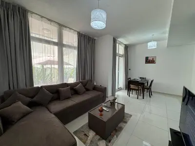 a living room with a couch and a table at 3 Bedroom Villa in Vardon Cluster Damac Hills 2 Peaceful Family Retreat By al sarya Holiday Homes in Dubai