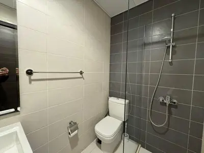 a bathroom with a toilet and a shower at 3 Bedroom Villa in Vardon Cluster Damac Hills 2 Peaceful Family Retreat By al sarya Holiday Homes in Dubai