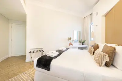 a large white bedroom with a large white bed at Damac Maison Mall Street! 2 Bedroom, 1-minute to Dubai Mall! in Dubai