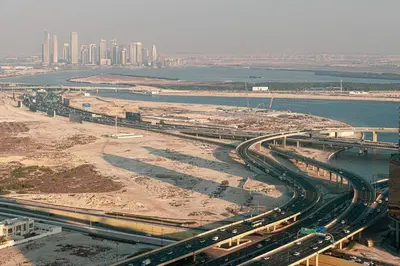 an aerial view of a city with a river and a bridge at Damac Maison Mall Street! 2 Bedroom, 1-minute to Dubai Mall! in Dubai