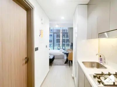 a small white bathroom with a sink and a tub at Charming Studio with Balcony in Azizi Riviera in Dubai