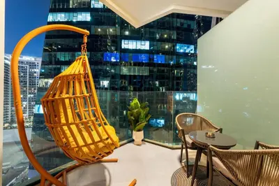 a room with a large window with a table and chairs at Miami Vibes | Canal View | Fully Furnished Studio in Dubai