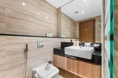 a bathroom with a sink and a toilet at Miami Vibes | Canal View | Fully Furnished Studio in Dubai