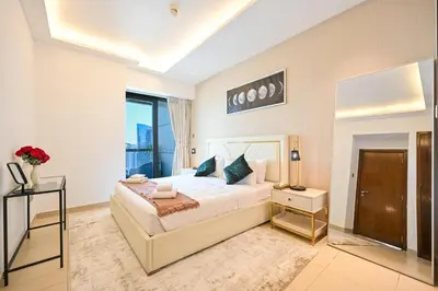 a bedroom with a large bed and a large window at Luxe 2BR with Fountain Views and Walk-Around Terrace in Dubai