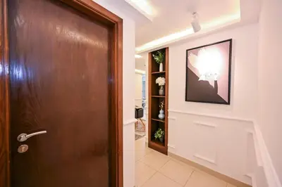 a hallway with a door and a picture on the wall at Luxe 2BR with Fountain Views and Walk-Around Terrace in Dubai