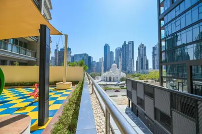 a view of the city from the balcony of a building at Luxe 2BR with Fountain Views and Walk-Around Terrace in Dubai