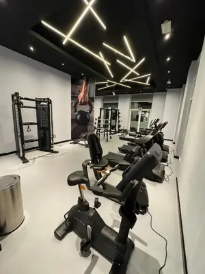 a row of exercise bikes in a gym at Cozy Studio Apartment in Dubai