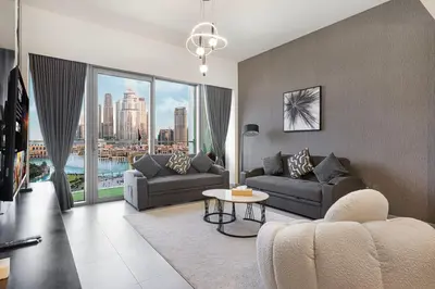 a living room with a couch and a table and a large window at Luxury Grande Suites by Hostiva - Full Burj Khalifa View in Dubai