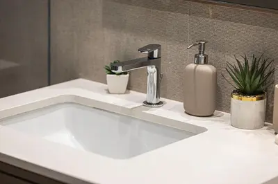 a white bathroom sink with a faucet at Luxury Grande Suites by Hostiva - Full Burj Khalifa View in Dubai