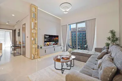 a large living room with a couch and a table at Luxury Grande Suites by Hostiva - Full Burj Khalifa View in Dubai
