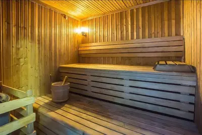 a wooden sauna with a wooden floor and a tub at Luxury Casa - Marina Diamond 2 in Dubai