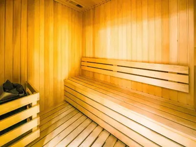 a sauna with wood paneling and two benches in it at Trillionaire Business Bay with Private Jacuzzi in Dubai