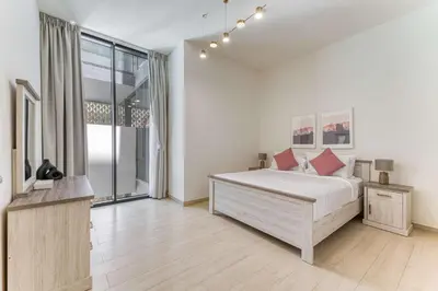 a white bedroom with a bed and a large window at PVH - Cosy 2BR Plus Study - Binghatti Crescent in Dubai
