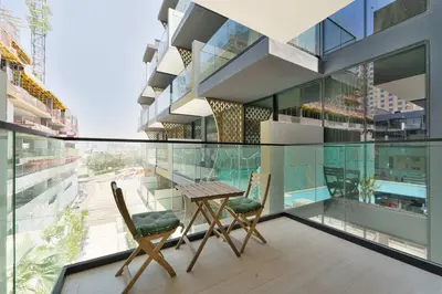 a balcony with two chairs and a table on a building at PVH - Cosy 2BR Plus Study - Binghatti Crescent in Dubai