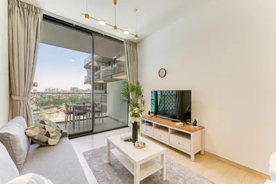 a living room with a couch and a tv at PVH - Cosy 2BR Plus Study - Binghatti Crescent in Dubai