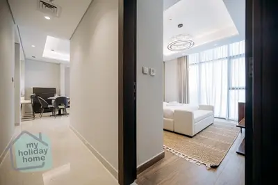 a living room with a couch and a bed in a room at Luxurious - Comfy 2BR in Business Bay - City Views in Dubai