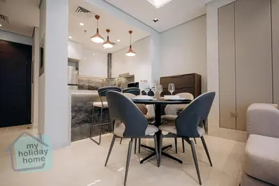 a dining room with a table and chairs at Luxurious - Comfy 2BR in Business Bay - City Views in Dubai